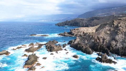 Aerial tracking view of ocean waves and rocks, Tenerife, Canary islands, Spain Stock Footage 253066329