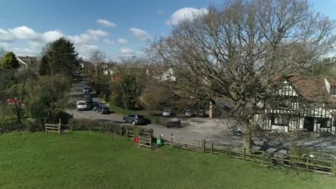 Aerial Tracking a White Van Passing English Pub Stock Footage 159213264