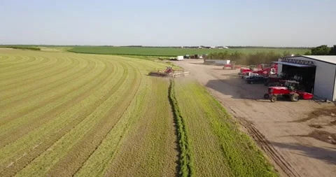 Aerial of Tractor and Rake next to Shed with Equipment Stock Footage 221861583