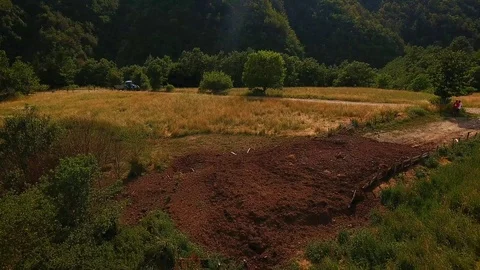 Aerial: tractor driving down an old dirt road  Stock Footage 112175208