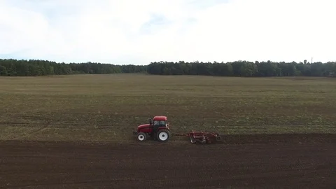 Aerial, tractor in a field, side view Stock Footage 74227540
