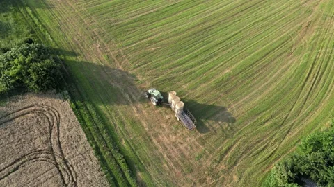 Aerial Tractor Picking Hay Balls at Field Stock Footage 134892053