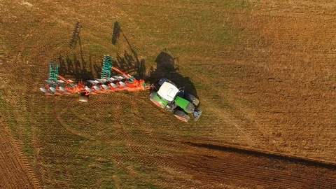 AERIAL : Tractor plowing a field in the spring - 4K UHD - germany Stock Footage 88348031