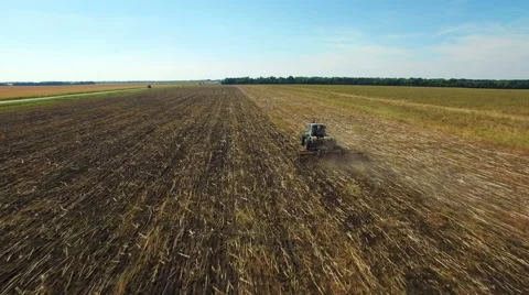 Aerial: Tractor plowing the soil Stock Footage 55015331