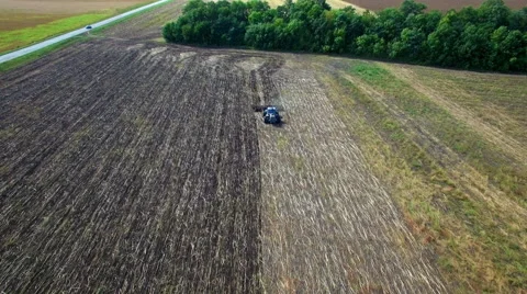 Aerial: Tractor plowing the soil Stock Footage 55070538