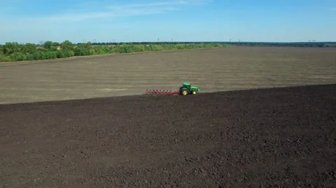 Aerial: Tractor plowing the soil Stock Footage 55433370
