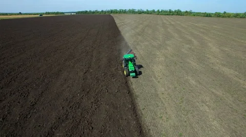 Aerial: Tractor plowing the soil Stock Footage 55438666