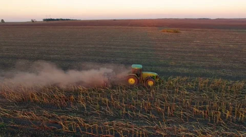 Aerial: Tractor plowing the soil on sunset Stock Footage 55801583