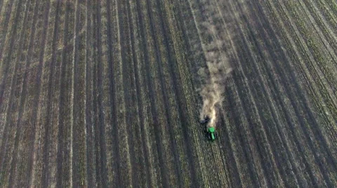 Aerial: Tractor plowing the soil on sunset Stock Footage 55804552
