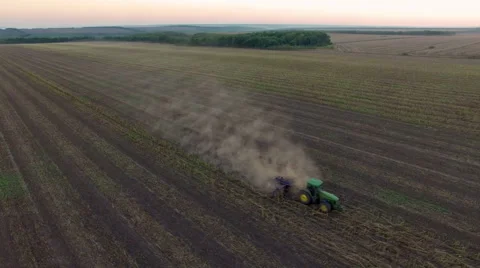 Aerial: Tractor plowing the soil on sunset Stock Footage 55808229