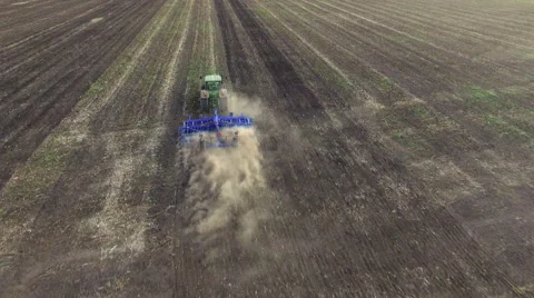 Aerial: Tractor plowing the soil on sunset Stock Footage 55809953