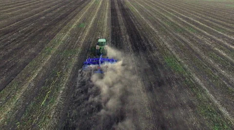 Aerial: Tractor plowing the soil on sunset Stock Footage 55810136