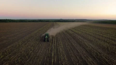 Aerial: Tractor plowing the soil on sunset Stock Footage 55810256