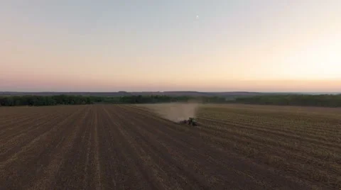 Aerial: Tractor plowing the soil on sunset Stock Footage 55810678
