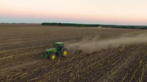 Aerial: Tractor plowing the soil on sunset Stock Footage 55811044