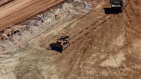 Aerial of tractor pushing dirt in mining pit in Utah Stock Footage 335836381
