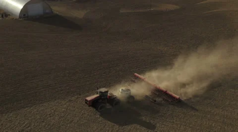 Aerial - Tractor seeding spring wheat Video stock 22479534