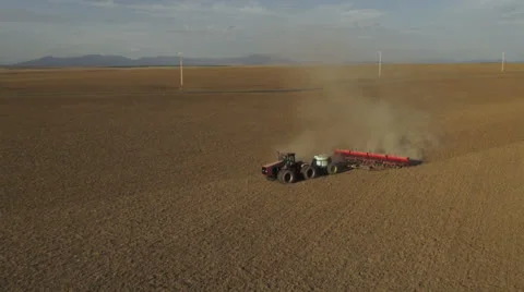 Aerial - Tractor seeding spring wheat Video stock 22481825