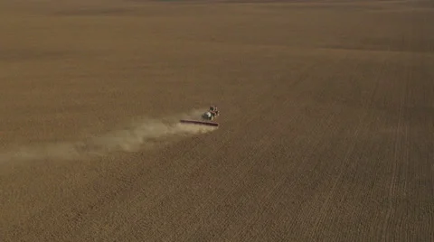 Aerial - Tractor seeding spring wheat Video stock 22486637