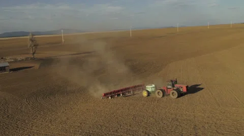 Aerial - Tractor seeding spring wheat Video stock 22494598
