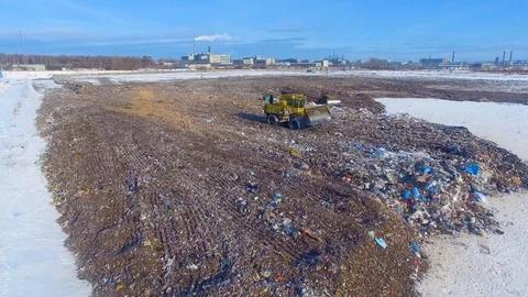 Aerial: tractor working at the garbage dump. Landfill, garbage dump, trash dump Stock Footage 73230325