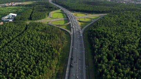 AERIAL. Traffic interchange. Top view of the road, city and forest. Summer video Video stock 109042013