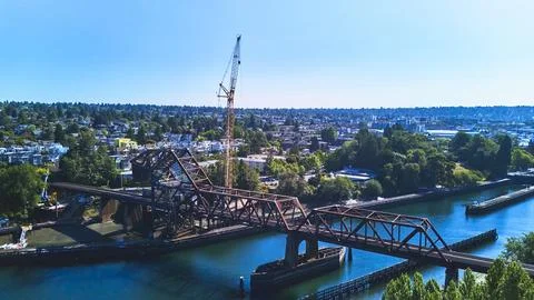 Aerial Train Bridge and Construction Crane Over Waterway in Seattle Stock Photos