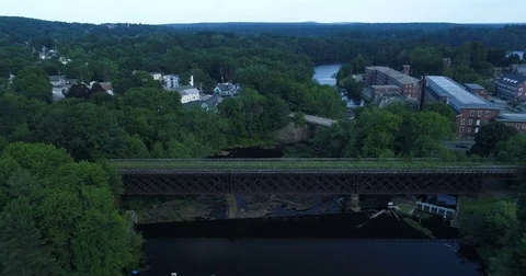 Aerial of Train Bridge Over Calm New England River Stock Footage 78176235