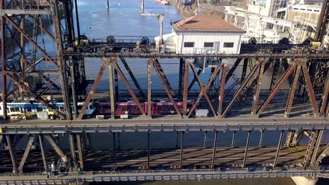 Aerial of a train crossing a bridge going over the river in Portland, Oregon. Stock Footage 147240108