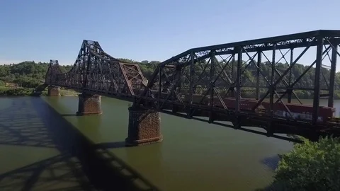 Aerial of train crossing a bridge over the Ohio River in Beaver County Stock Footage 71273281