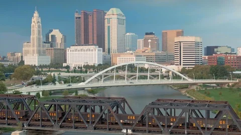 Aerial: Train crossing bridge on the Scioto River, Columbus, Ohio, USA Stock Footage 127393349