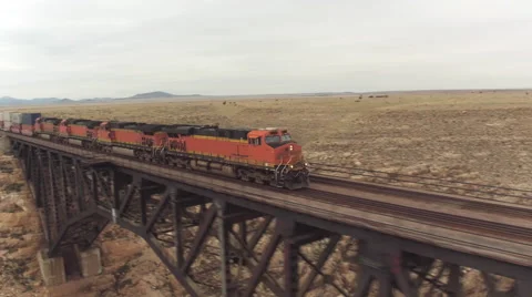 AERIAL: Train crossing steel arch railroad bridge across the Canyon Diablo Stock Footage