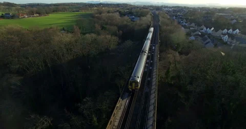 Aerial: Train on Forth Rail Bridge in Queensferry, Edinburgh, Scotland Stock Footage 65298228