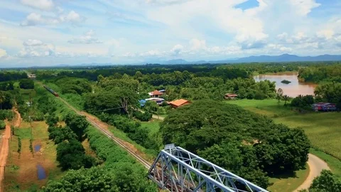 Aerial: Train on Forth Rail Bridge in Uttaradit, Thailand Stock Footage 79733251