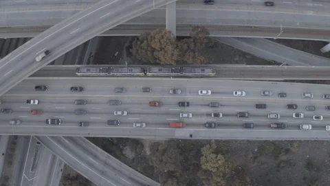 Aerial train moving through traffic Stock Footage 85646026