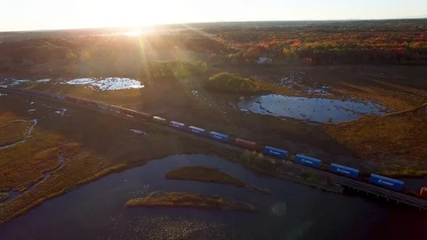 Aerial - Train Passing through marsh in Maine Stock Footage 100469920