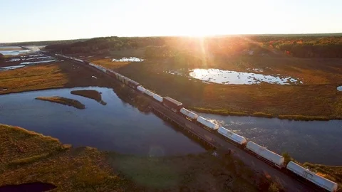 Aerial - Train passing through sunset in Maine Fall Stock Footage 100468072