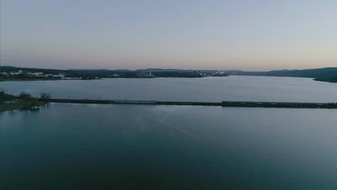 Aerial of Train Passing on Tracks Over the Hudson River at Sunset Stock Footage 94657510