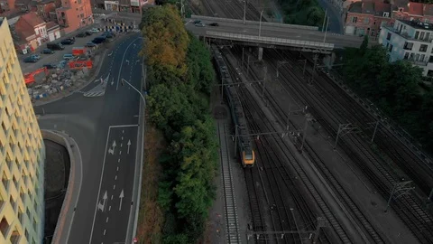Aerial train on sunset next to road and bridge in Leuven city 動画素材 123150673