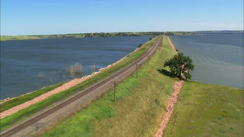 Aerial of train track on bridge over river, Road continues on into water Stock Footage 109451447