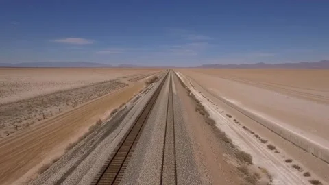 Aerial of train tracks through a desolate desert area Stock Footage 150944940