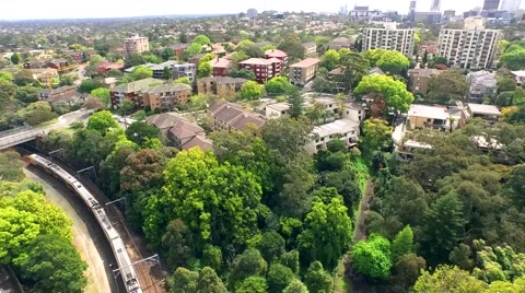 Aerial of trains through suburbs Stock Footage 62461972