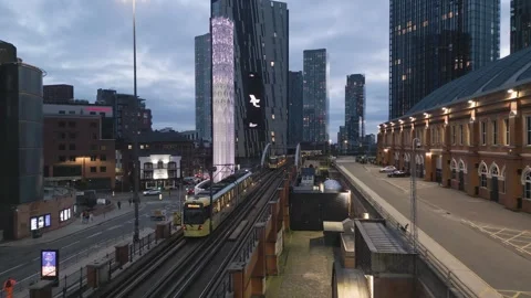 Aerial of trams and Tower of light, Deansgate, Manchester, England Stock Footage 257556236