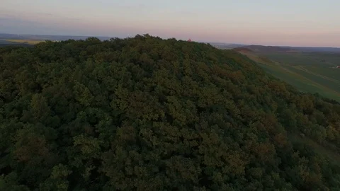 Aerial of tree covered mountain at dusk Stock Footage 116203639