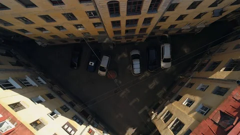 Aerial triangular courtyard well Saint Petersburg old house Road traffic River   Video stock 130006450