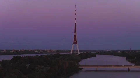 Aerial twilight of Riga TV Tower from Zakusala over Daugava River Stock Footage 340847638