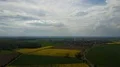 Aerial twisting shot yellow blooming rape fields and thick clouds 4k 4k or 4k+ Resolution