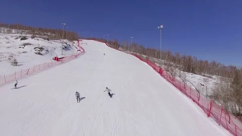 AERIAL: Two beginners of the skier learn to move down the ski slope. Stock Footage 81669101