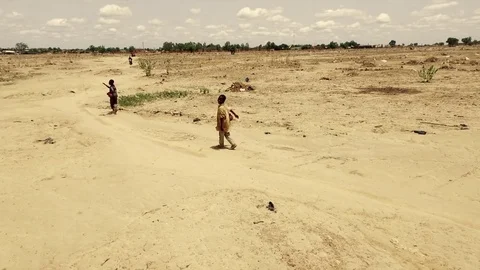 Aerial of two boys walking in a desertic area Stock Footage 80365548