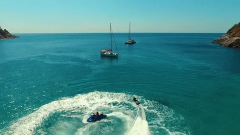 Aerial: Two men doing flyboard near the beach. Stock Footage 70449375